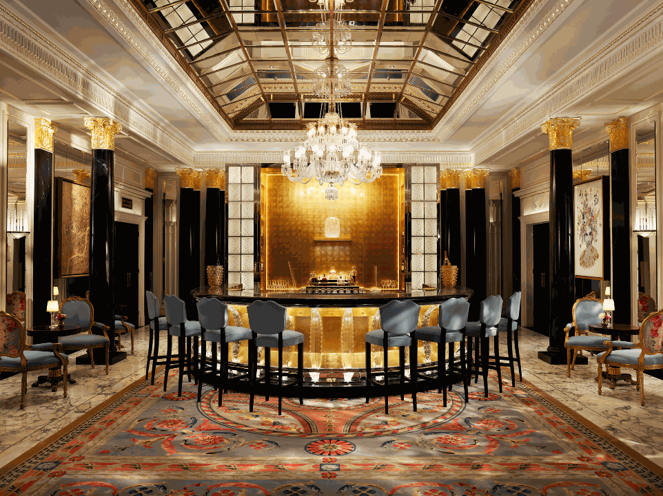 Stunning uplit bar area with grand chandelier and marble columns